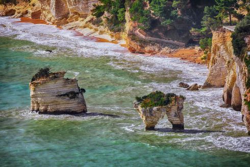 islets Faraglioni di Puglia in summer Adriatic sea bay Baia Delle Zagare